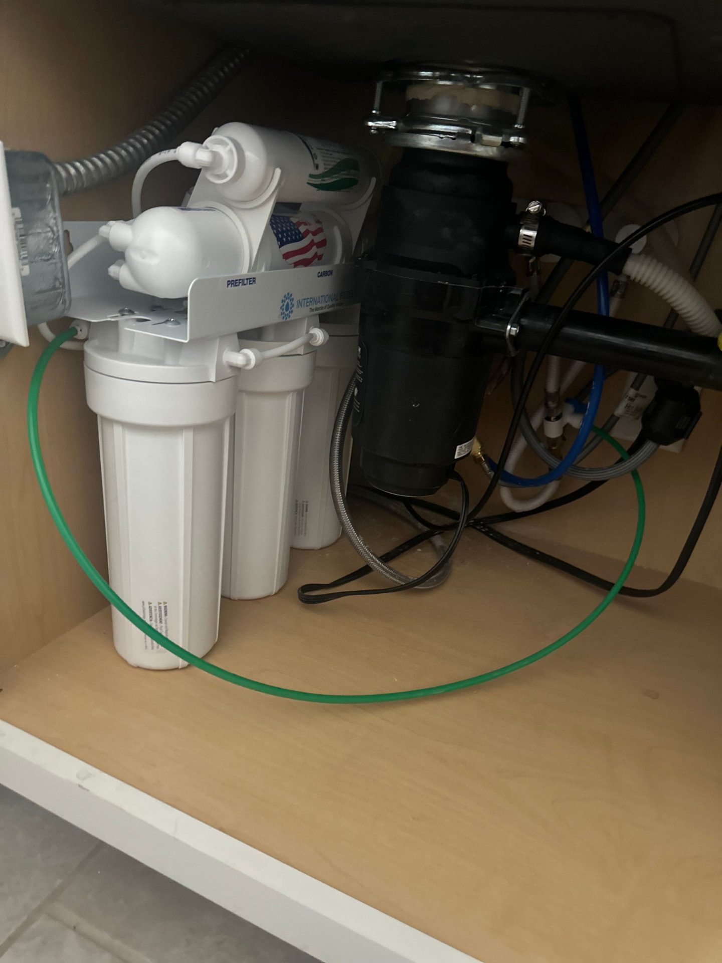 Whole-house water softener and filtration system installed in a garage